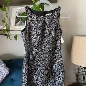 Stunning black dress with silver rose detailing.